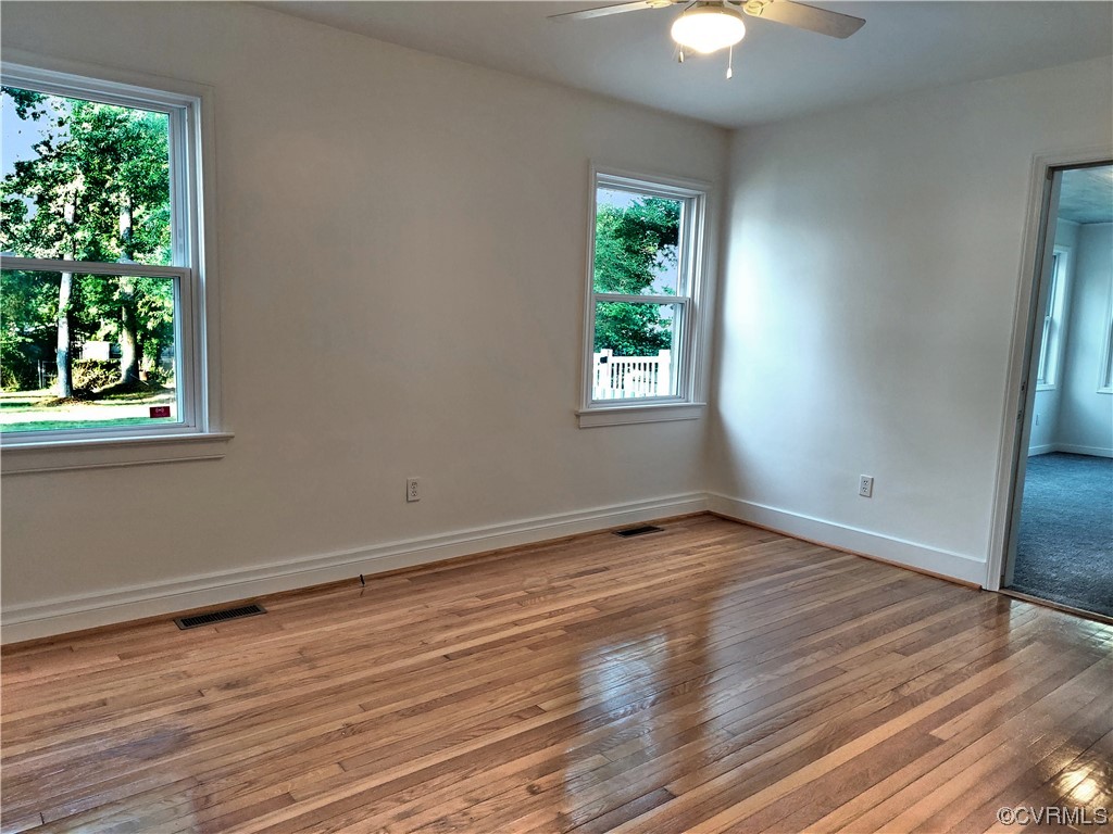 14413 Rivermont Road Chester, VA 23836 - Photo 8 of 21 a view of an empty room with wooden floor and a window