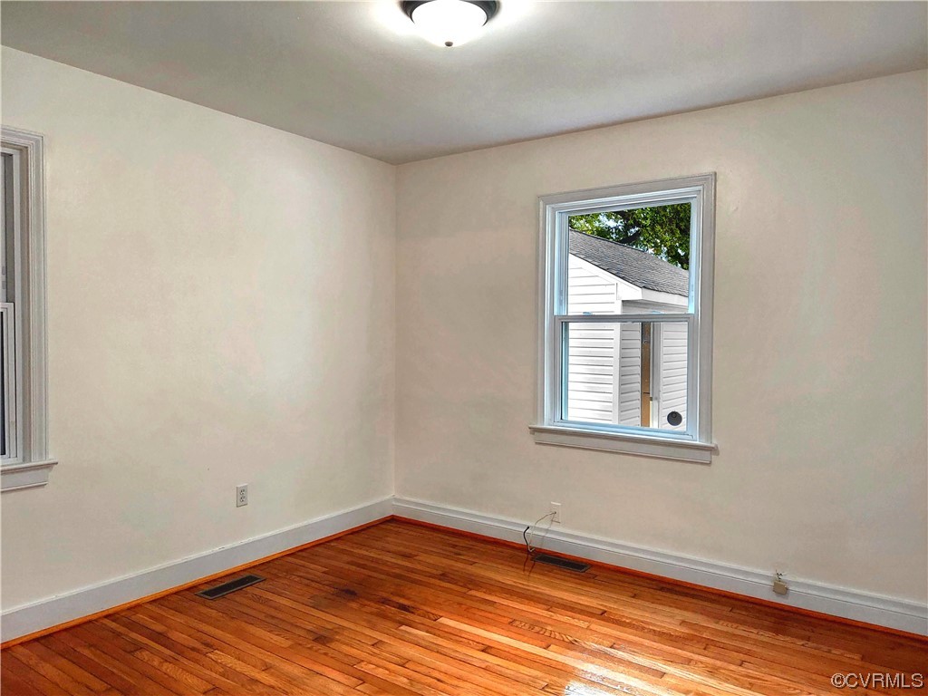 14413 Rivermont Road Chester, VA 23836 - Photo 10 of 21 a view of an empty room with wooden floor and a window