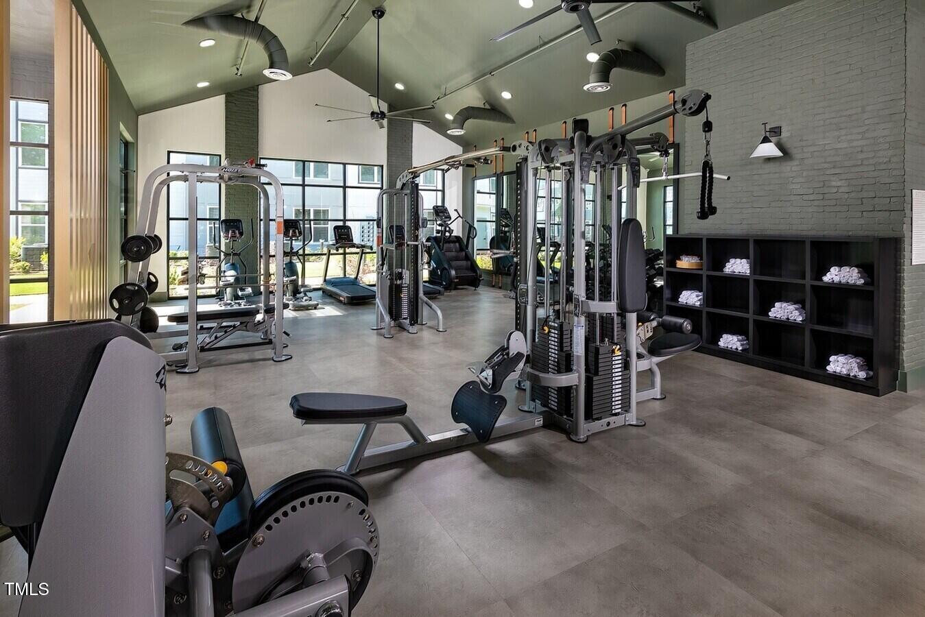 821 Hanbury Way, Unit A1 1 Raleigh, NC 27607 - Photo 5 of 43 a room with gym equipment and a large window