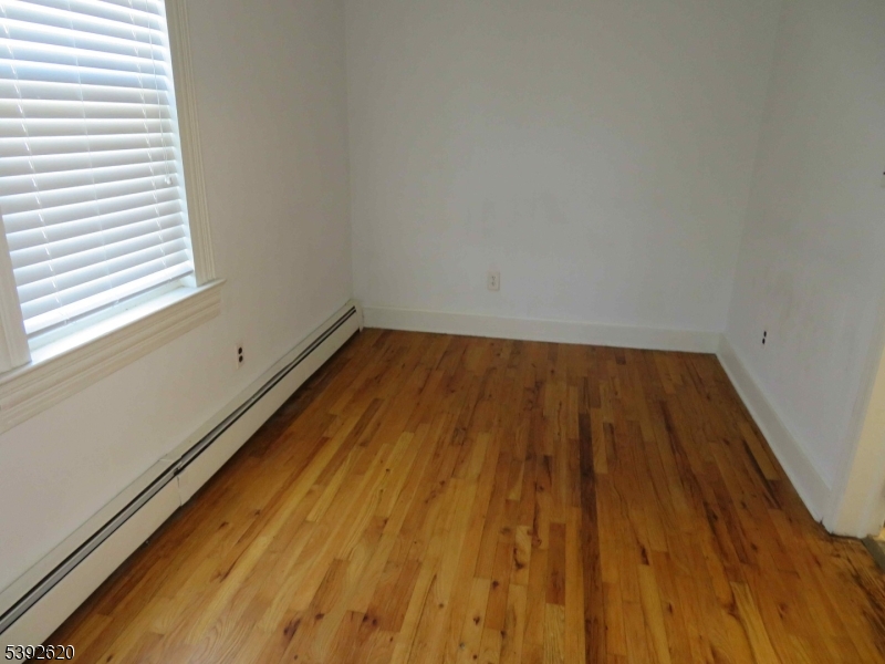 297 Center Street, Unit A Landing, NJ 07850 - Photo 11 of 18 a view of a room with wooden floor and small window
