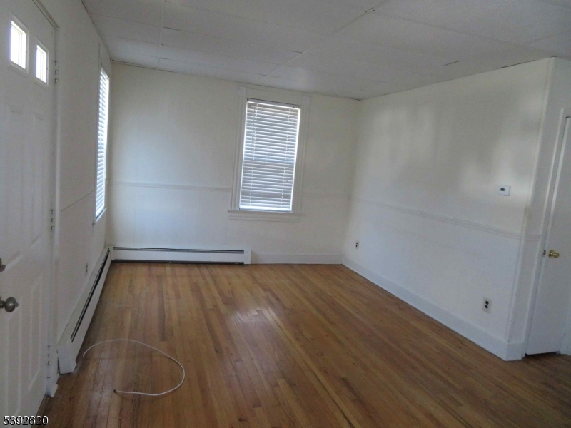 297 Center Street, Unit A Landing, NJ 07850 - Photo 5 of 17 an empty room with wooden floor and windows