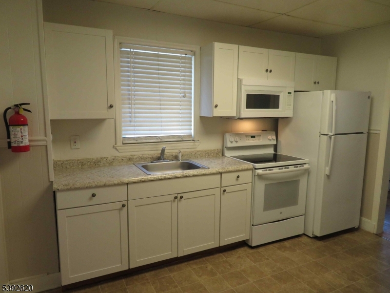 297 Center Street, Unit A Landing, NJ 07850 - Photo 8 of 18 a kitchen with stainless steel appliances granite countertop a sink a refrigerator and a stove