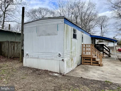 a view of a house with a wooden fence