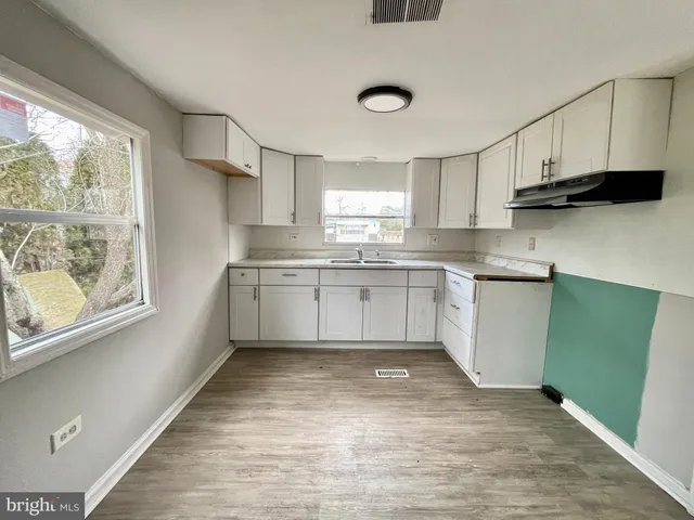 a kitchen with a sink a window and stainless steel appliances