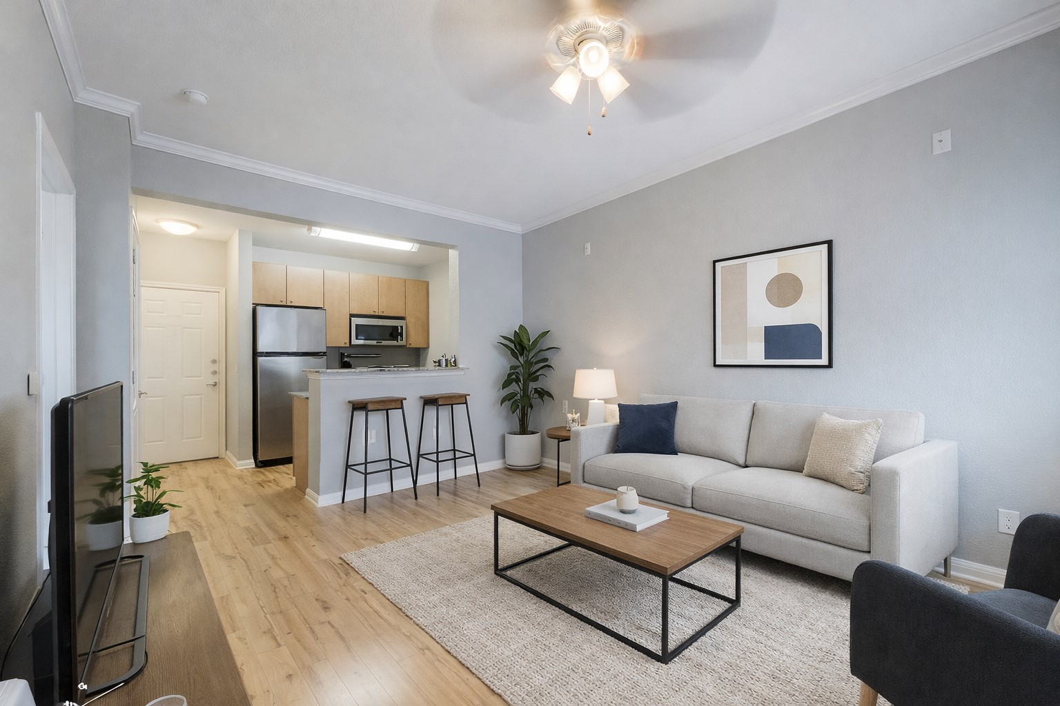 a living room with furniture a large mirror and a flat screen tv