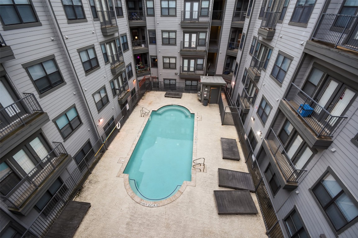2502 Leon Street, Unit 313 Austin, TX 78705 - Photo 26 of 27 a view of a swimming pool with outdoor seating and stairs