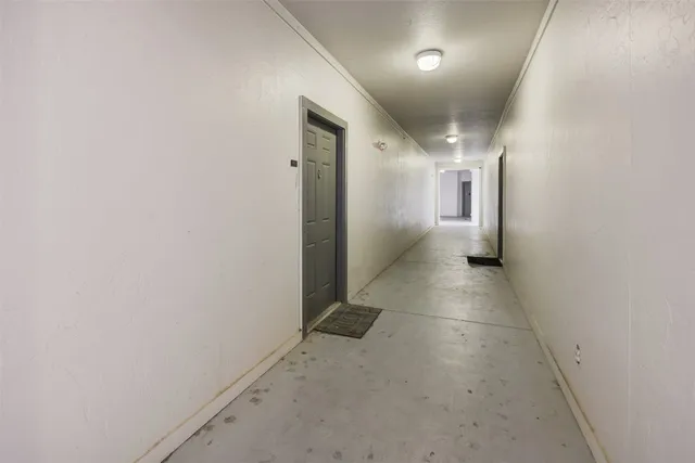 a kitchen with a stove and wooden floor