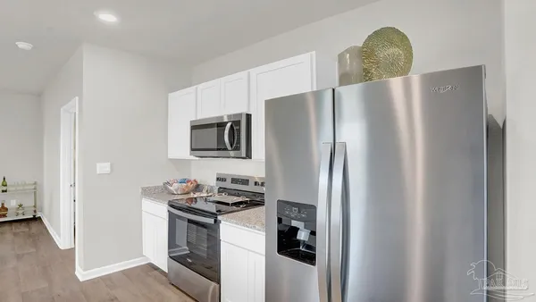 a kitchen with sink and refrigerator