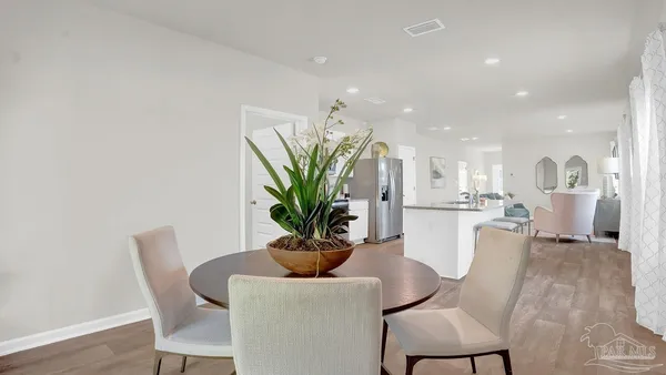 a view of a dining room with furniture and wooden floor