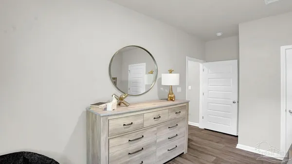 a bathroom with a granite countertop tub sink and mirror with toilet