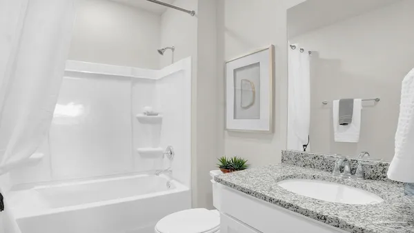 a bedroom with a large bed and a large window