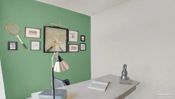 a living room with furniture and large windows