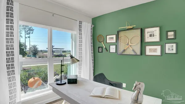 a living room with furniture and a floor to ceiling window