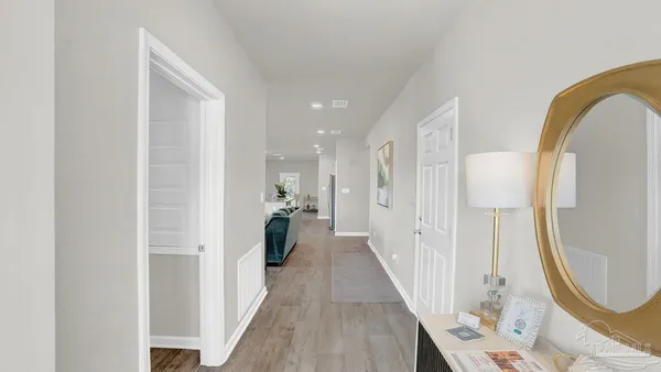 a kitchen with refrigerator and chairs