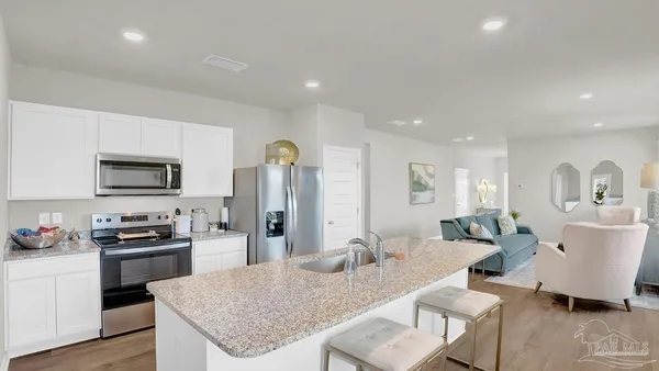 a kitchen with stainless steel appliances white cabinets and a stove