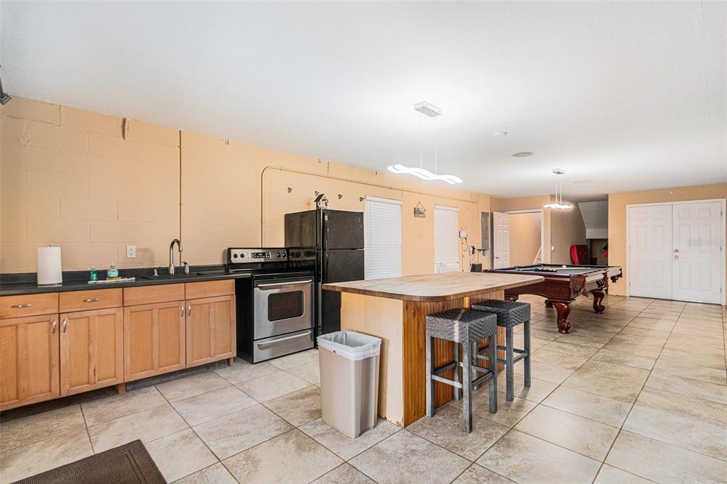 1316 Apollo Beach Boulevard South Apollo Beach, FL 33572 - Photo 16 of 47 a kitchen with lots of counter top space and stainless steel appliances