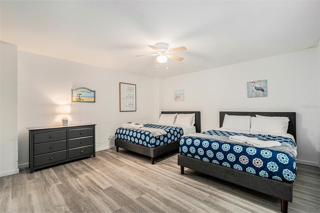 1316 Apollo Beach Boulevard South Apollo Beach, FL 33572 - Photo 18 of 47 a bedroom with two beds and painting on the wall