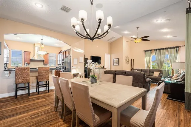 a kitchen with granite countertop stainless steel appliances a sink stove and cabinets