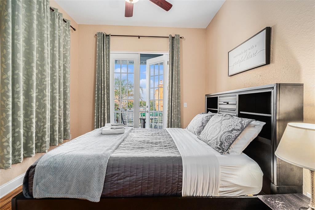 1316 Apollo Beach Boulevard South Apollo Beach, FL 33572 - Photo 33 of 47 a bedroom with a balcony a bed and a television