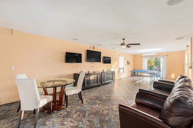a view of a house with swimming pool and sitting area