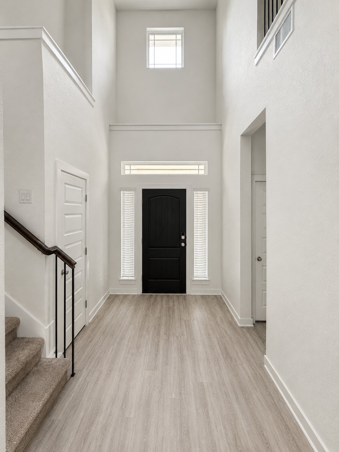 1213 Bryson Rdg Trail Leander, TX 78641 - Photo 3 of 16 A grand entrance with high ceilings and wood-style flooring welcomes all who enter.