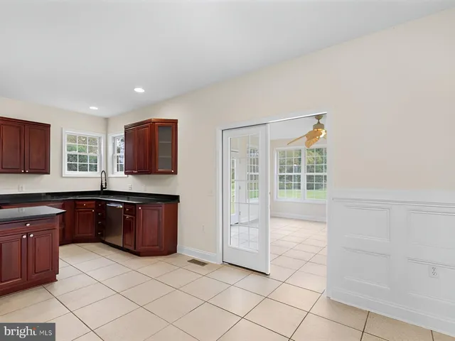 a kitchen with stainless steel appliances granite countertop a stove a refrigerator and a sink