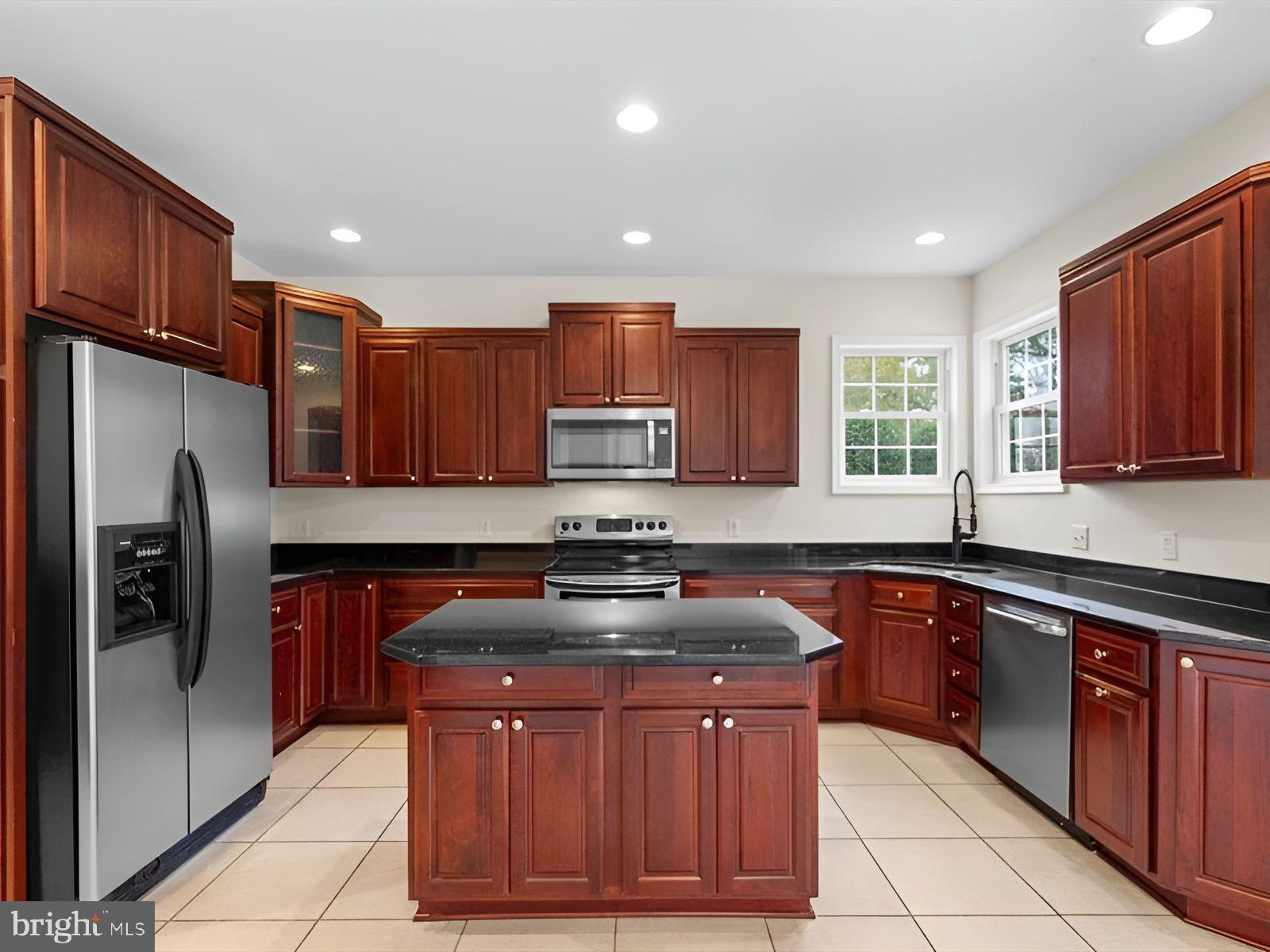 3236 Noble Farm Road Eden, MD 21822 - Photo 15 of 57 a kitchen with stainless steel appliances granite countertop wooden cabinets a stove a sink and a refrigerator