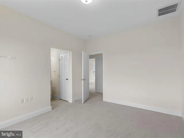 an empty room with a bathroom and a sink
