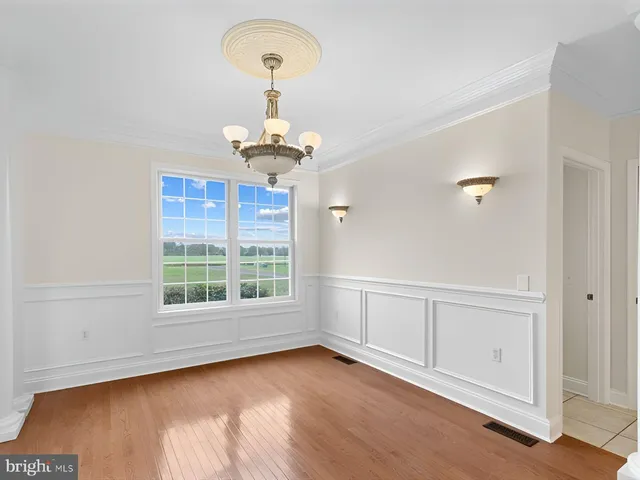a view of a dining room with furniture wooden floor and chandelier