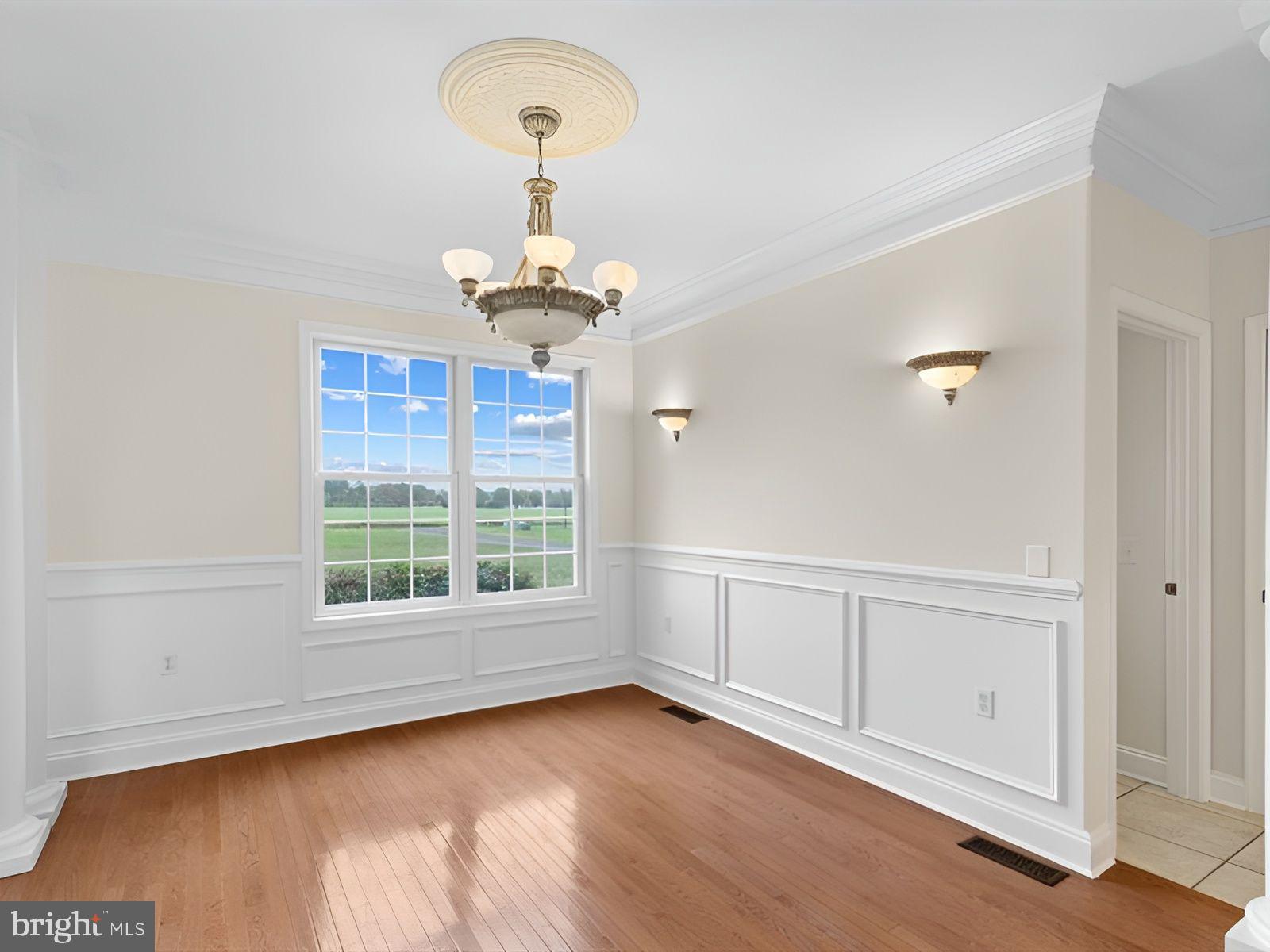 3236 Noble Farm Road Eden, MD 21822 - Photo 5 of 57 an empty room with wooden floor cabinet and windows