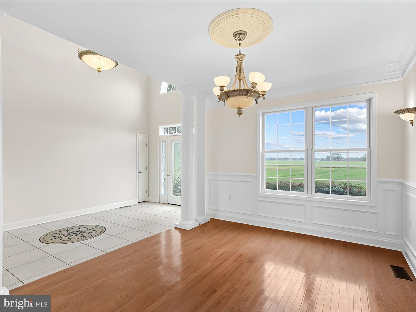 3236 Noble Farm Road Eden, MD 21822 - Photo 7 of 57 a view of an empty room with wooden floor and a window