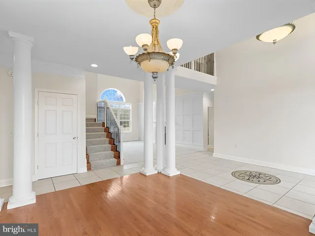 a living room with furniture a fireplace and a chandelier