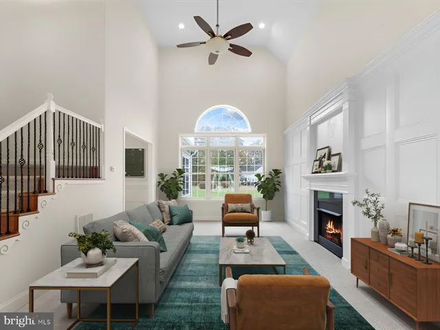 an empty room with fireplace fan and windows