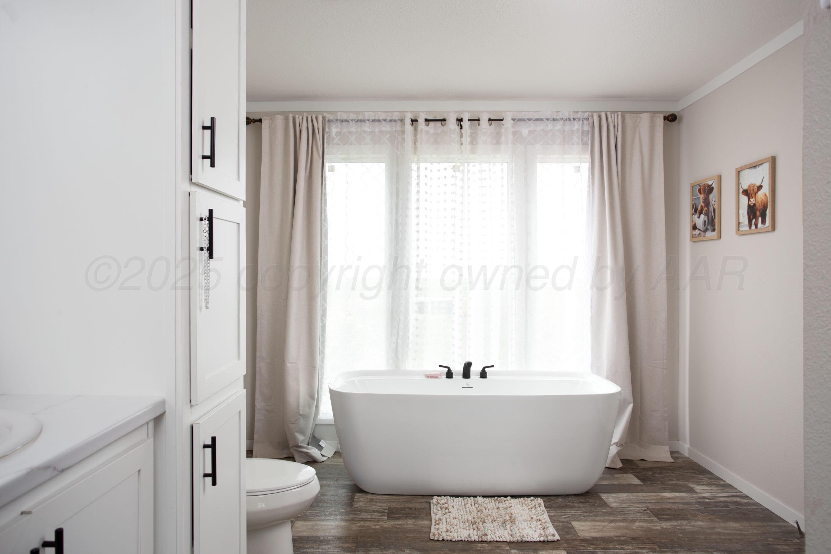 6300 Voorhees Road Amarillo, TX 79119 - Photo 15 of 27 a bathroom with a bathtub and sink