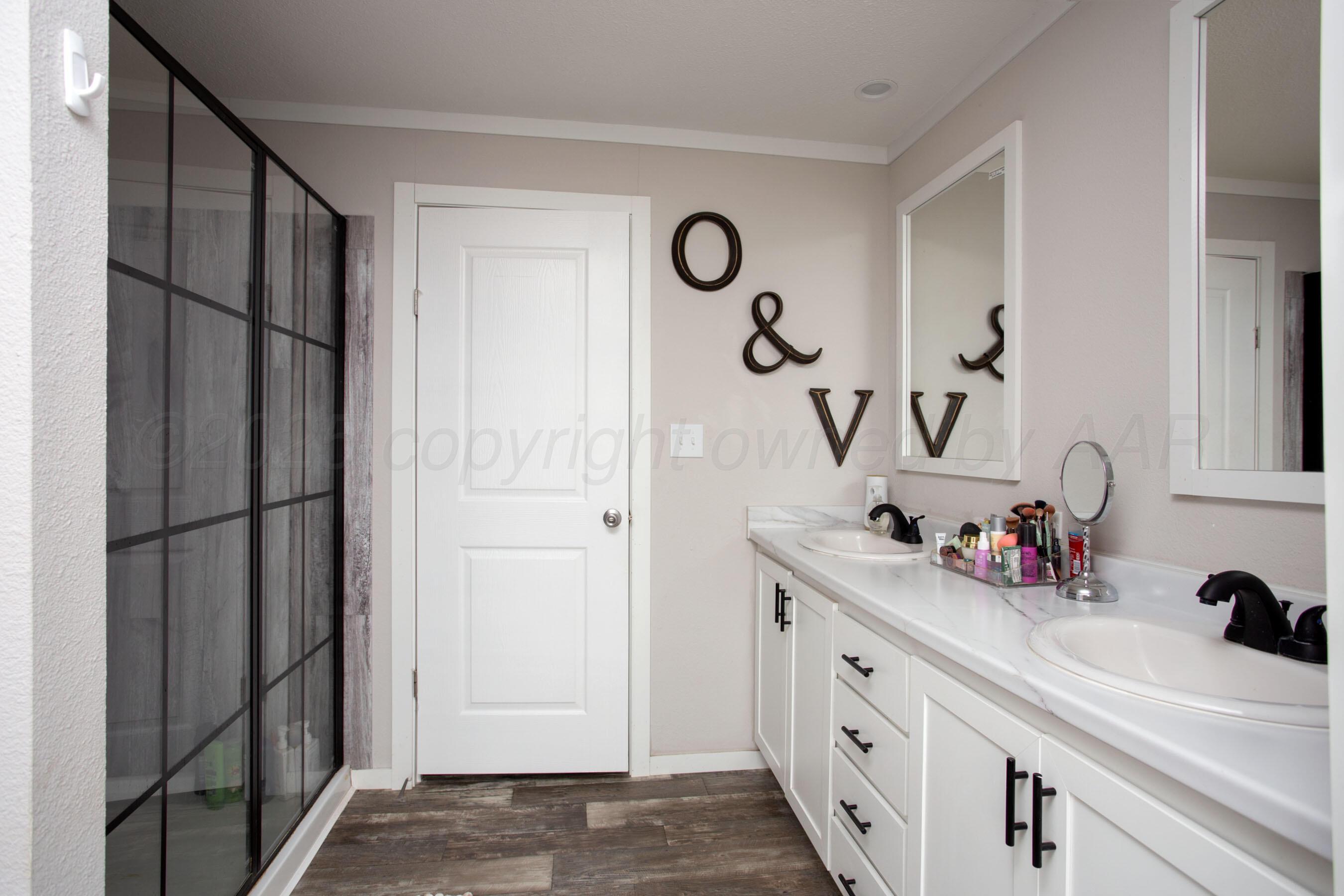 6300 Voorhees Road Amarillo, TX 79119 - Photo 18 of 27 a bathroom with a sink and mirror