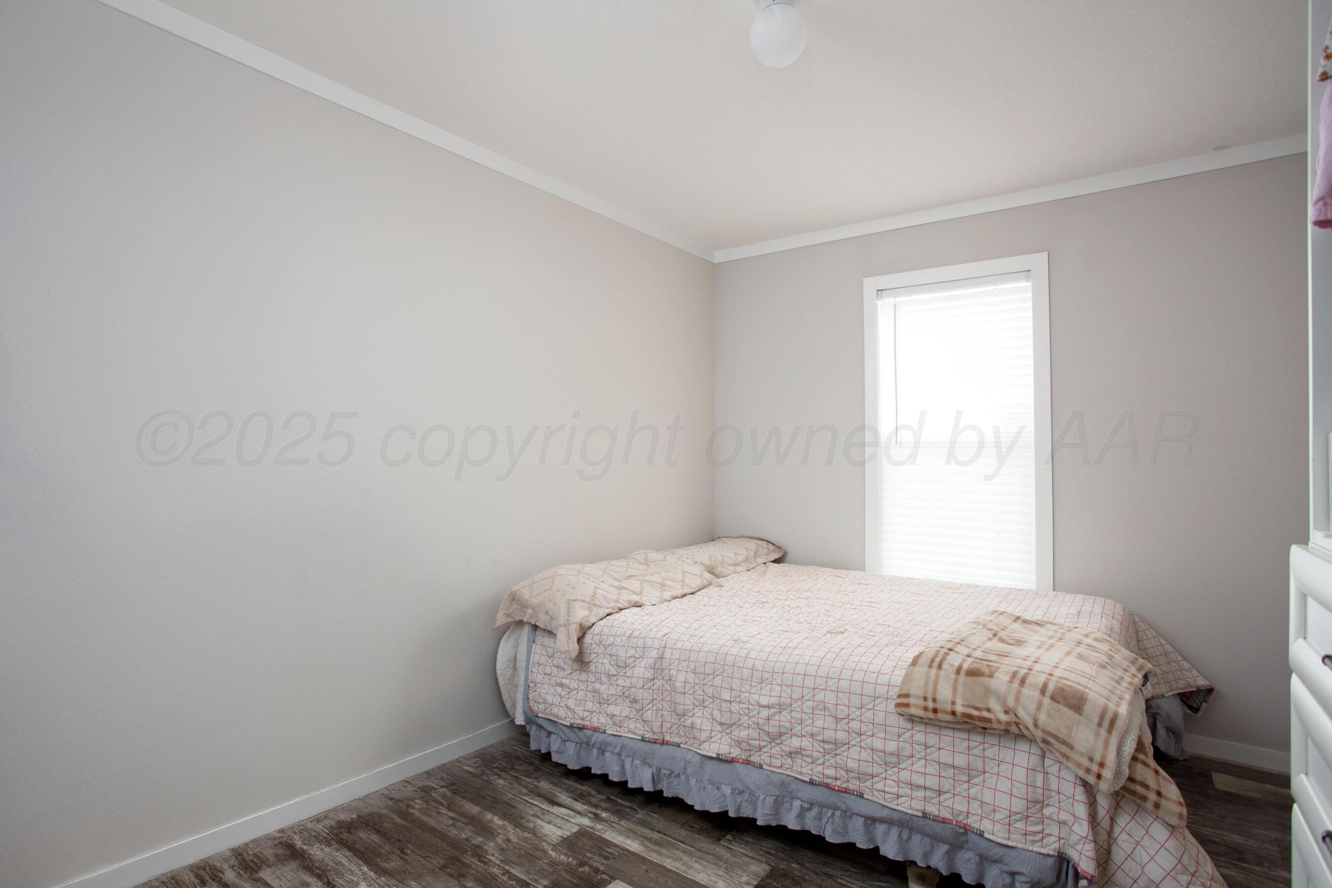 6300 Voorhees Road Amarillo, TX 79119 - Photo 20 of 27 a bedroom with a bed and a window