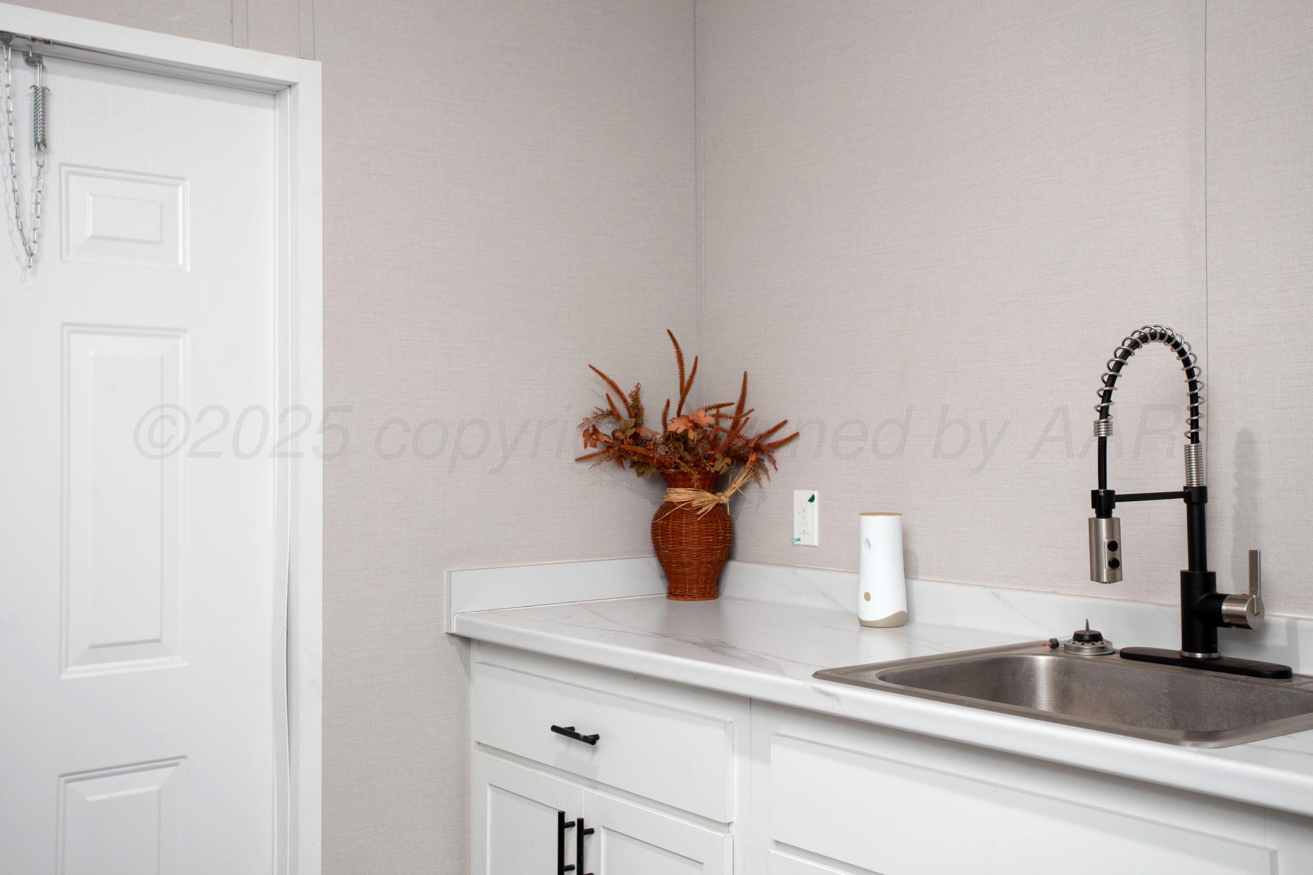 6300 Voorhees Road Amarillo, TX 79119 - Photo 25 of 27 a kitchen with a sink and a mirror