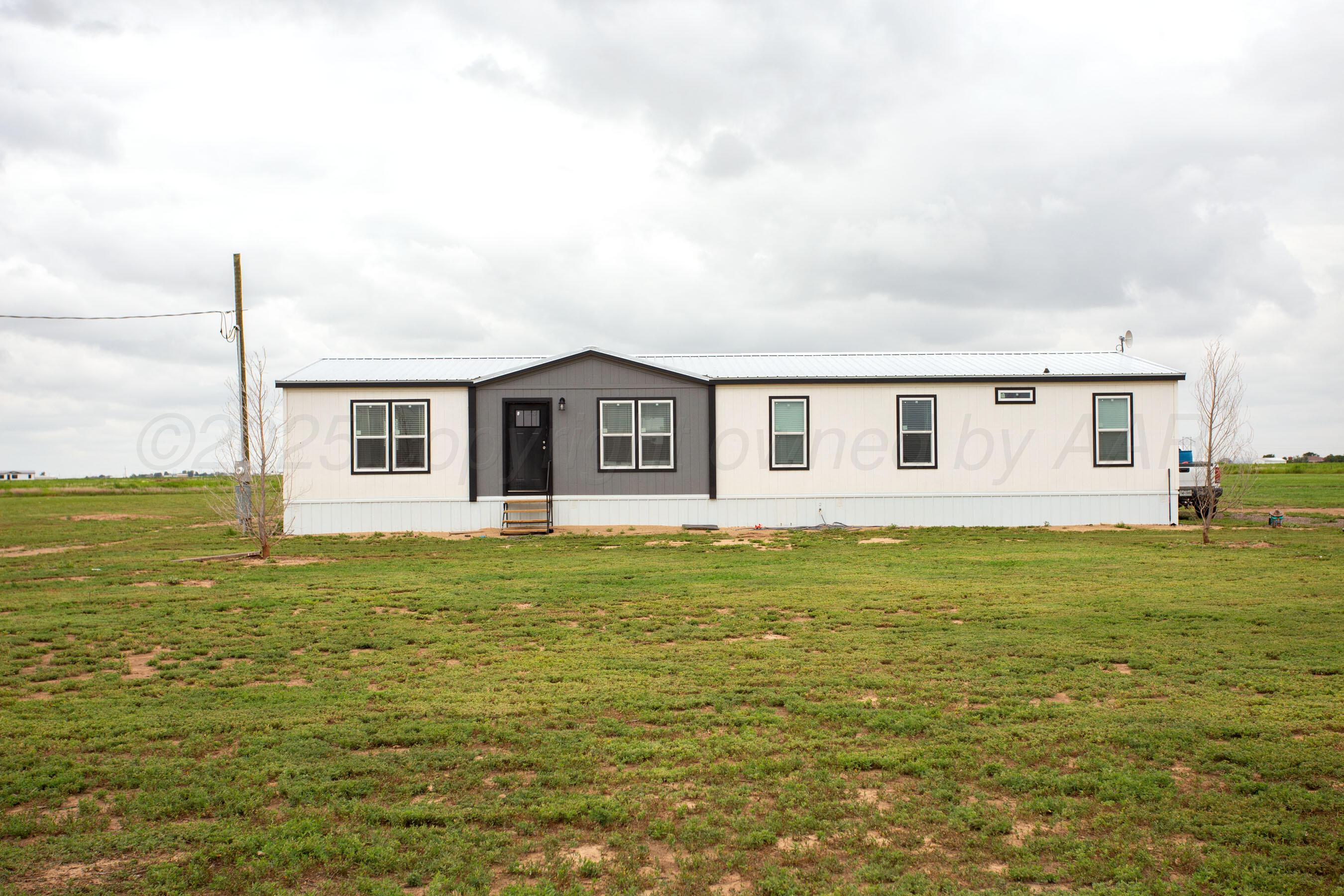 6300 Voorhees Road Amarillo, TX 79119 - Photo 26 of 27 a front view of a house with a garden