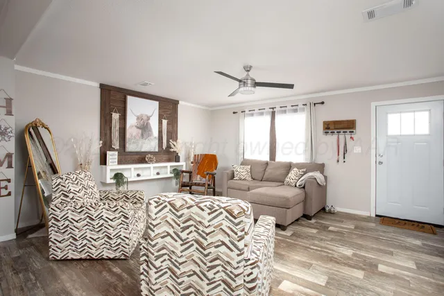 a living room with furniture and a large window