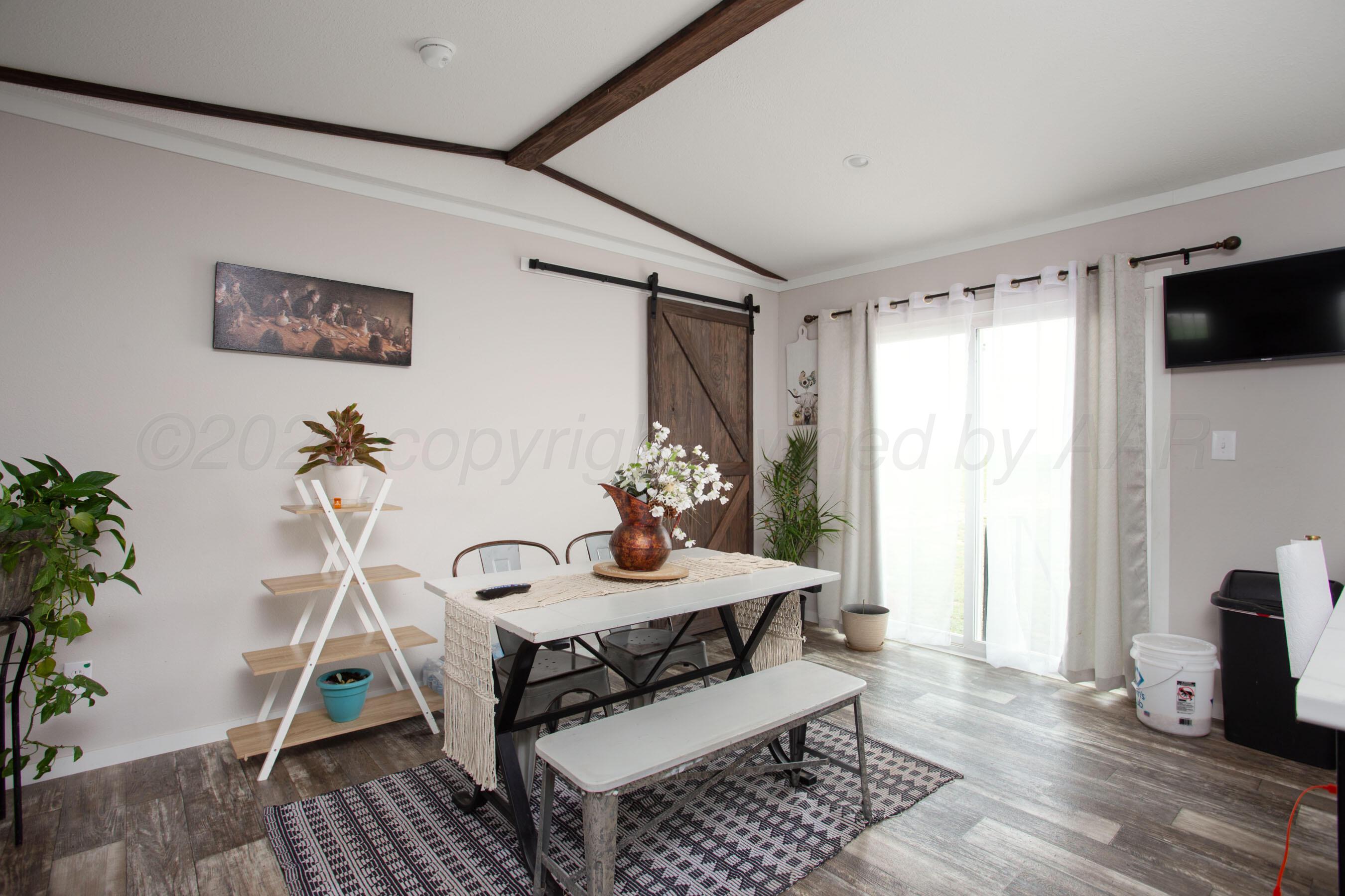 6300 Voorhees Road Amarillo, TX 79119 - Photo 9 of 27 a living room with furniture a wooden floor and a window