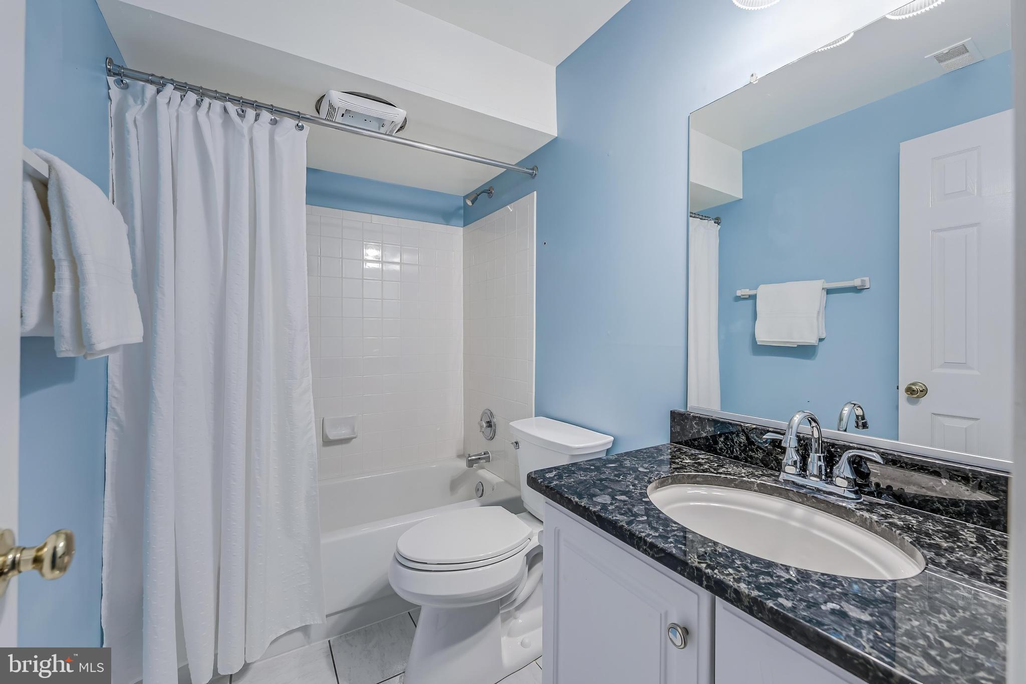 5501 Ashleigh Road Fairfax, VA 22030 - Photo 66 of 77 a bathroom with a granite countertop sink toilet and shower