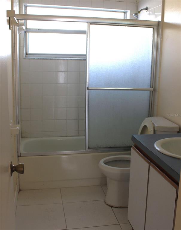 11100 Einbender Road Orlando, FL 32825 - Photo 13 of 26 a bathroom with a granite countertop sink a toilet and shower