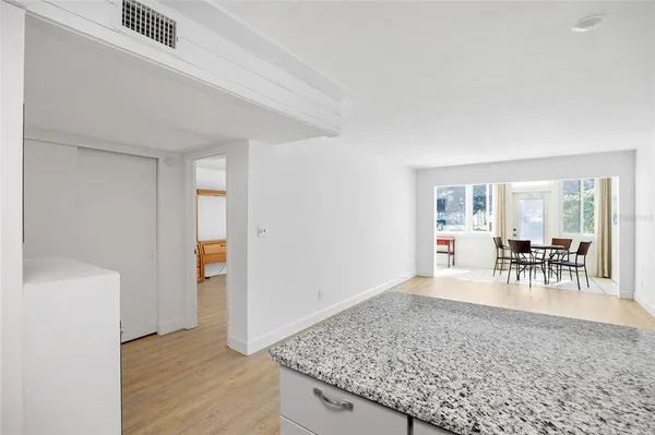a bedroom with a white bed and a window