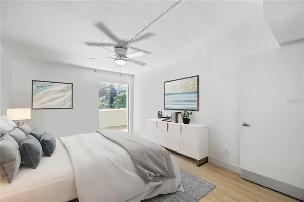 a view of an empty room with window and hardwood floor