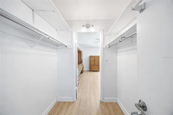 a view of walk in closet with empty racks