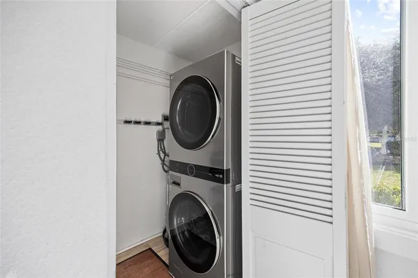 a dining room with furniture a chandelier and wooden floor