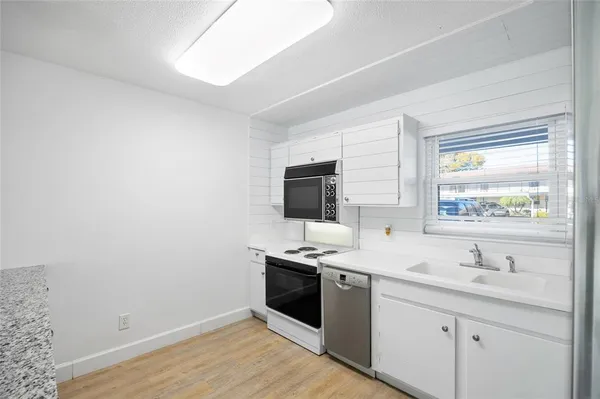 a kitchen with a refrigerator stove and sink
