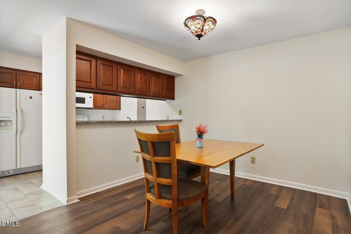 163 Springberry Lane Chapel Hill, NC 27517 - Photo 8 of 32 a view of a dining room with furniture and wooden floor