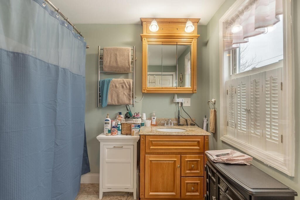 20 Washington Street Danvers, MA 01923 - Photo 11 of 39 a bathroom with a sink a vanity and a mirror
