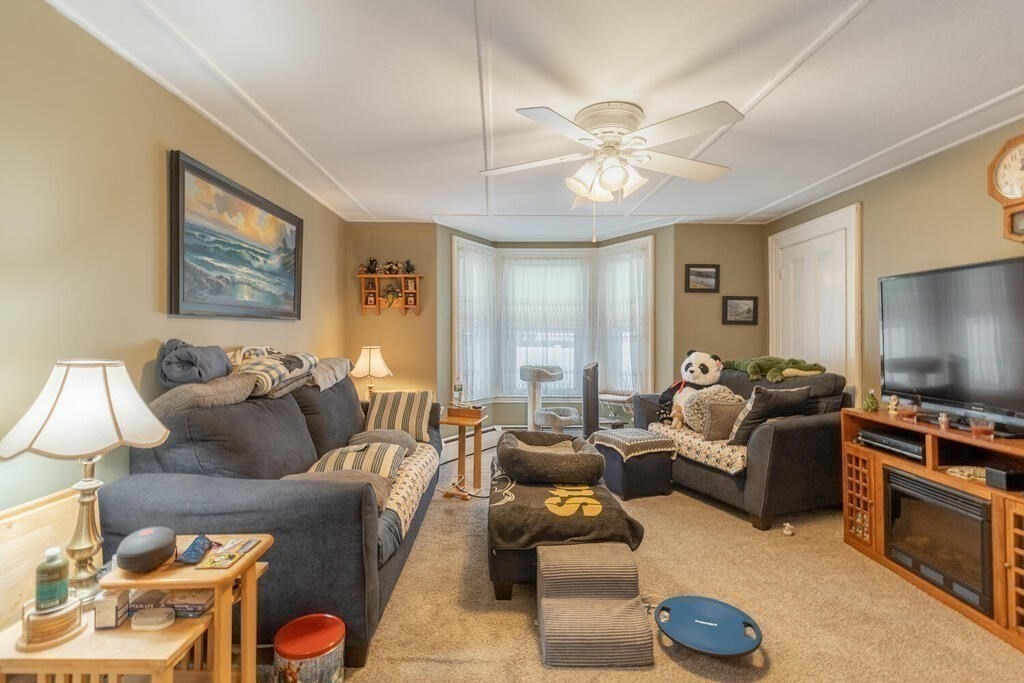 20 Washington Street Danvers, MA 01923 - Photo 14 of 39 a living room with furniture a ceiling fan and a window